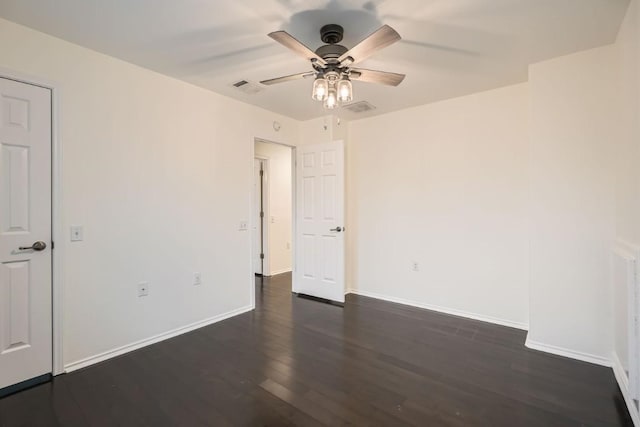 spare room with dark hardwood / wood-style floors and ceiling fan