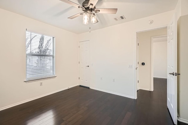 unfurnished room with ceiling fan and dark hardwood / wood-style flooring