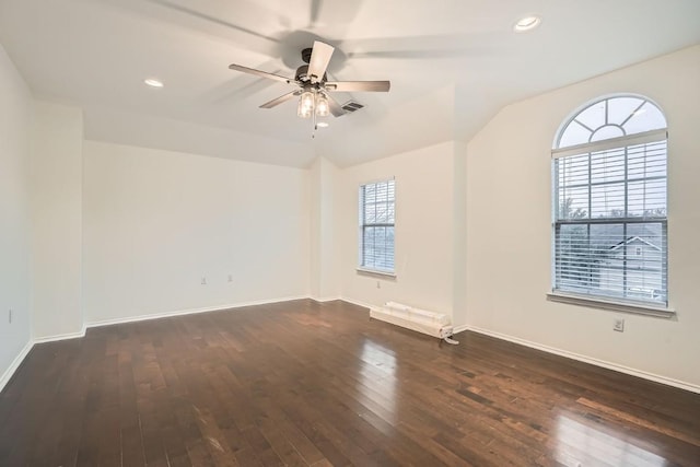 unfurnished room featuring ceiling fan, dark hardwood / wood-style flooring, and vaulted ceiling