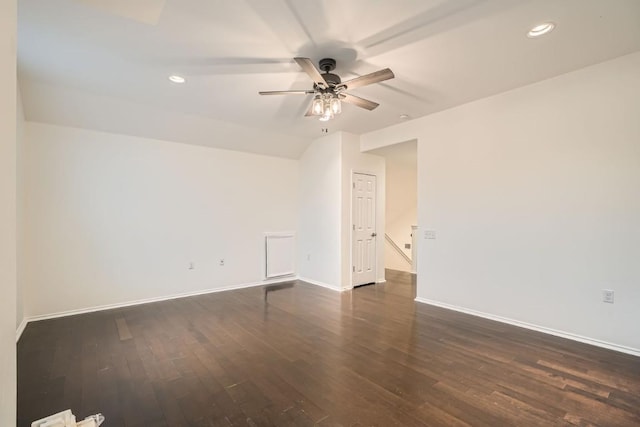 empty room with dark wood-type flooring, ceiling fan, and vaulted ceiling