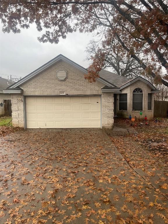 ranch-style house featuring a garage