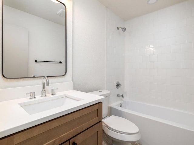 full bathroom featuring washtub / shower combination, vanity, and toilet