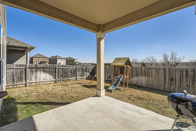 view of patio / terrace with area for grilling and a playground