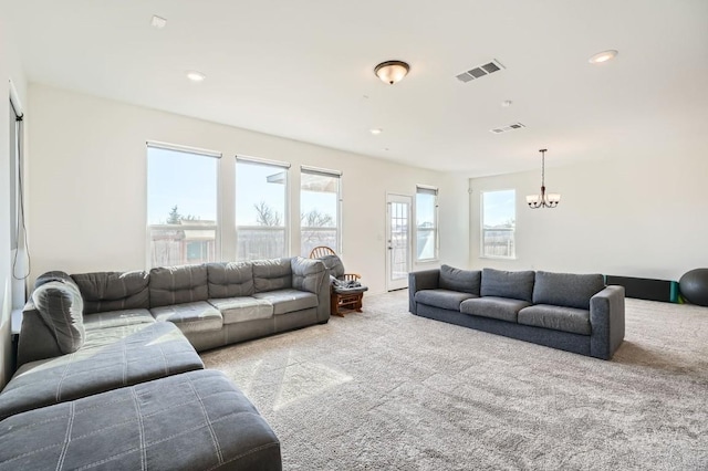 living room featuring light colored carpet and a notable chandelier