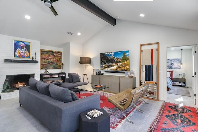 living room featuring light tile patterned flooring, ceiling fan, lofted ceiling with beams, and a brick fireplace