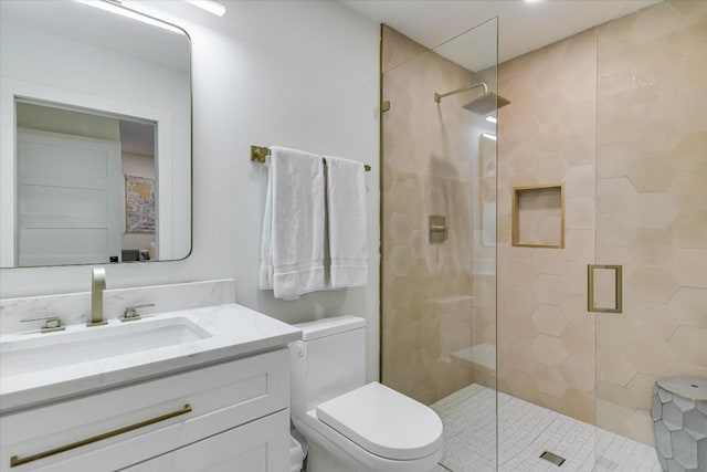 bathroom featuring vanity, toilet, and walk in shower