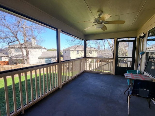 sunroom / solarium featuring plenty of natural light and ceiling fan