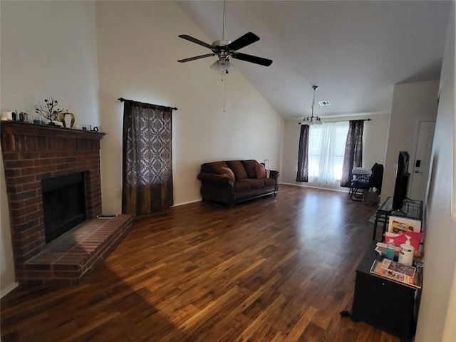 living room with ceiling fan, a brick fireplace, lofted ceiling, and dark hardwood / wood-style flooring