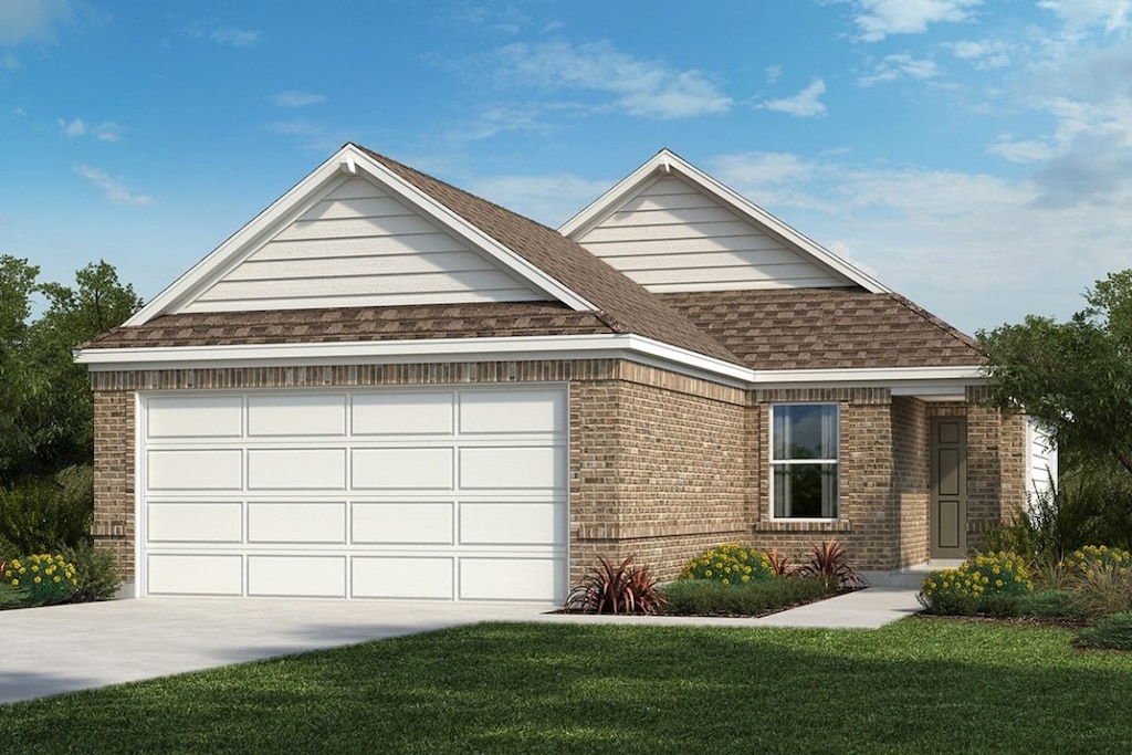 view of front of property with a garage and a front lawn