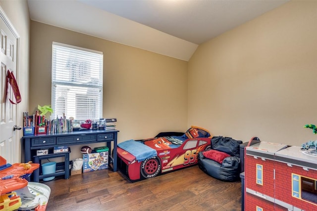 bedroom with dark hardwood / wood-style flooring and vaulted ceiling