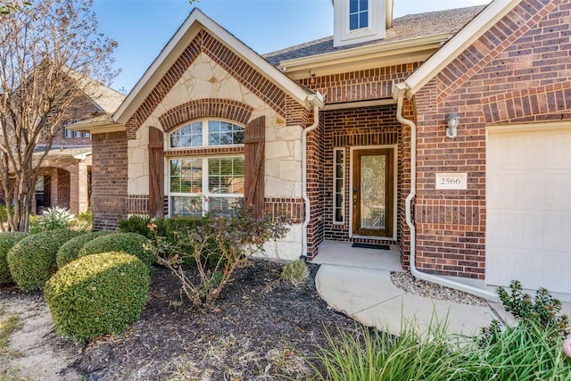 doorway to property with a garage