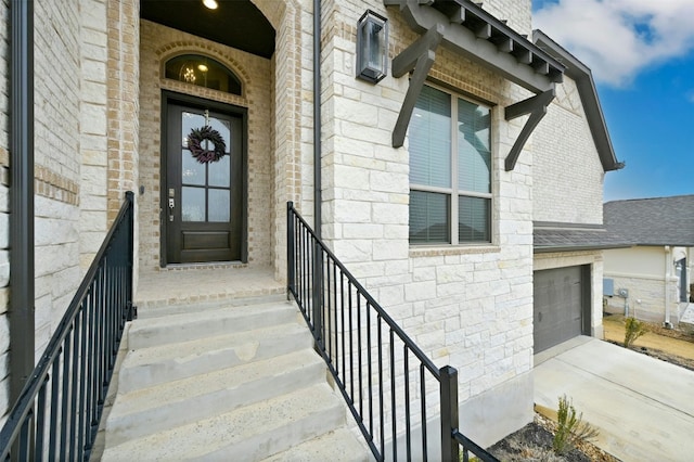 doorway to property with a garage