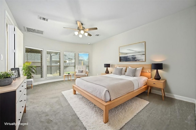 bedroom with ceiling fan and dark carpet