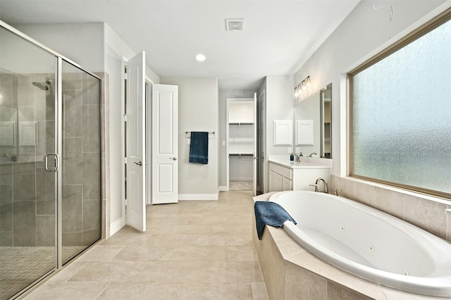 bathroom featuring tile patterned floors, vanity, and shower with separate bathtub