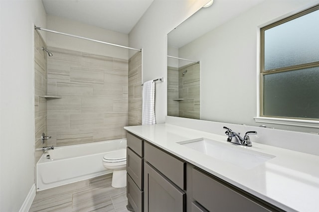 full bathroom with vanity, toilet, and tiled shower / bath combo