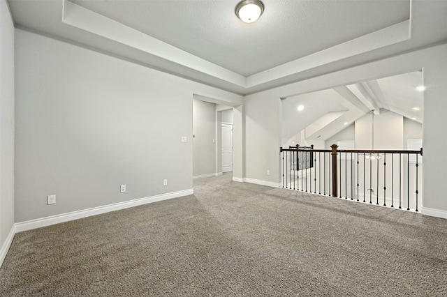 empty room with vaulted ceiling with beams and carpet