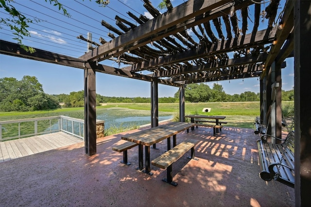 view of patio with a water view and a pergola