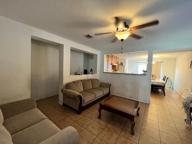 living room featuring light tile patterned floors and ceiling fan