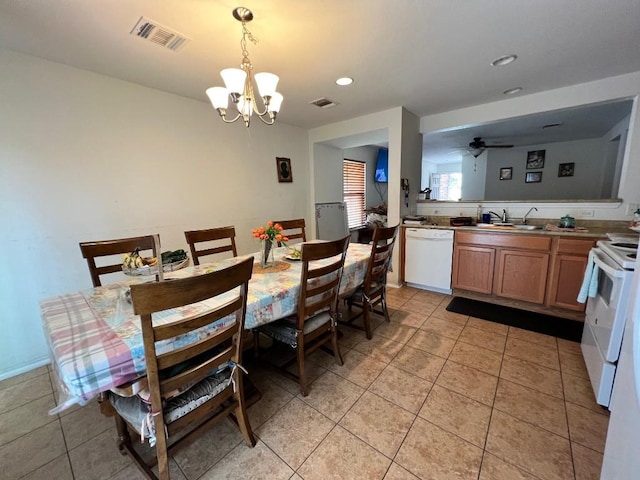 dining area with ceiling fan with notable chandelier, sink, and light tile patterned floors