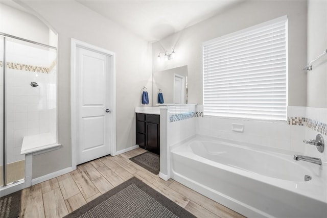 bathroom featuring vanity and shower with separate bathtub