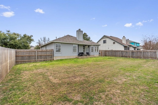 rear view of house featuring a yard and a patio