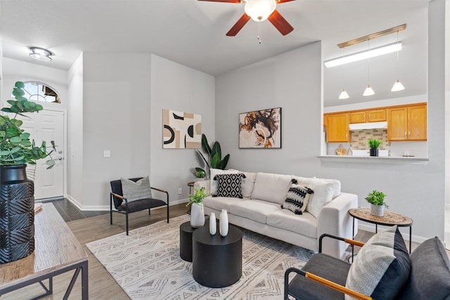 living room with hardwood / wood-style flooring and ceiling fan