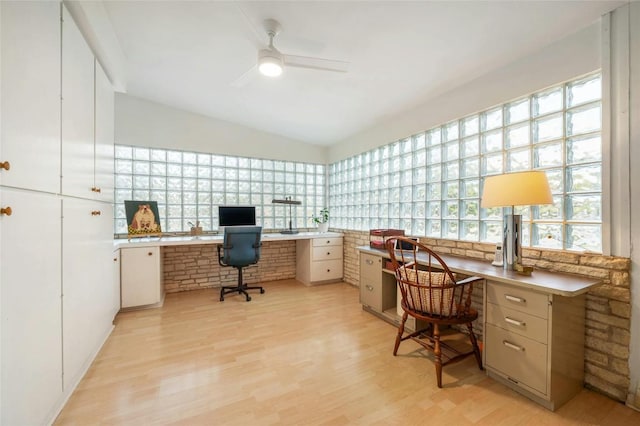 office area with ceiling fan, a healthy amount of sunlight, built in desk, and light wood-type flooring