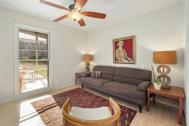 living room featuring ceiling fan and light wood-type flooring