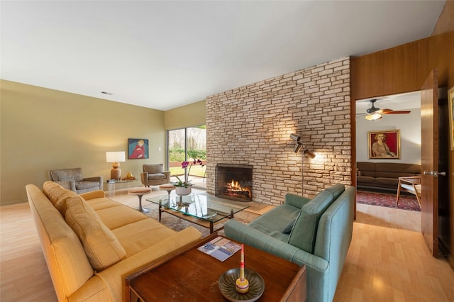 living room with light wood-type flooring and a fireplace