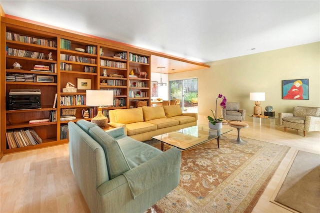 living room featuring light hardwood / wood-style floors and a notable chandelier