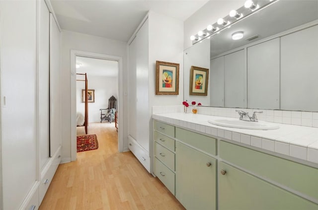 bathroom with hardwood / wood-style flooring and vanity