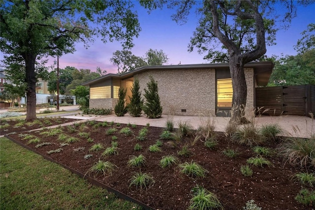 property exterior at dusk with a patio