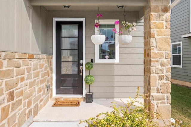 view of exterior entry featuring stone siding