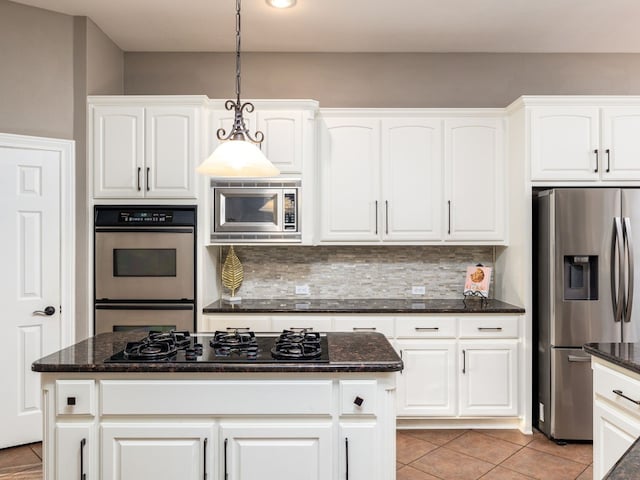 13312 Country Lake Dr, Austin, TX 78732 - kitchen featuring stainless steel appliances, decorative light fixtures, decorative backsplash, and dark stone counters