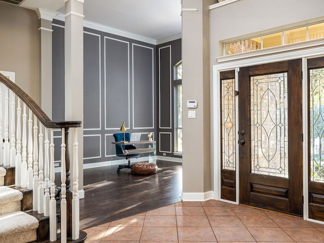 13312 Country Lake Dr, Austin, TX 78732 - tiled foyer entrance featuring a decorative wall, ornamental molding, plenty of natural light, stairs, and decorative columns
