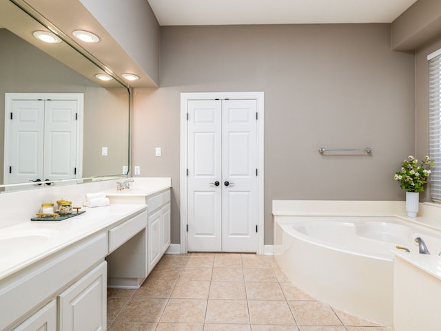 13312 Country Lake Dr, Austin, TX 78732 - full bathroom with double vanity, a bath, tile patterned floors, a closet, and recessed lighting