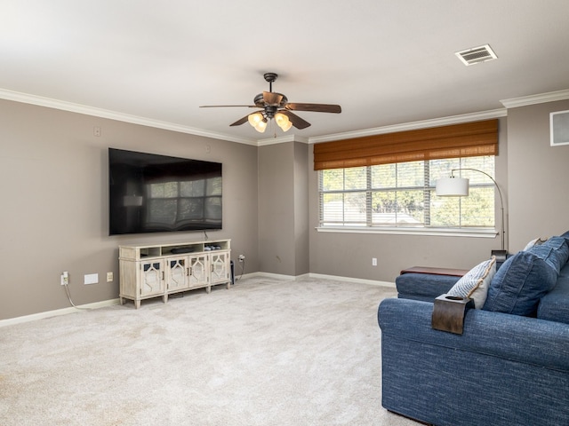 carpeted living room with ceiling fan and ornamental molding