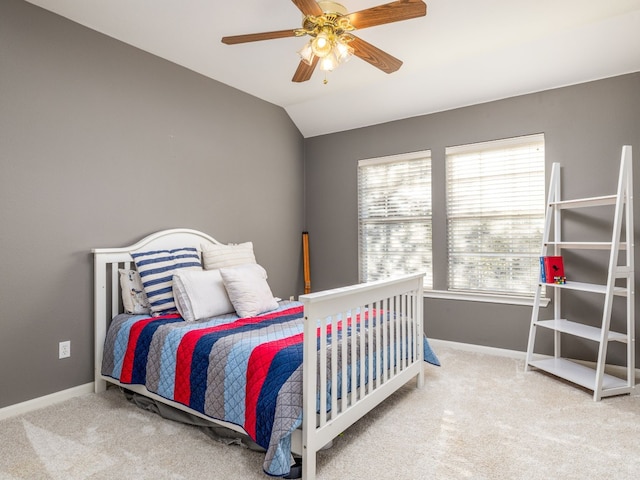 bedroom featuring lofted ceiling, ceiling fan, and carpet