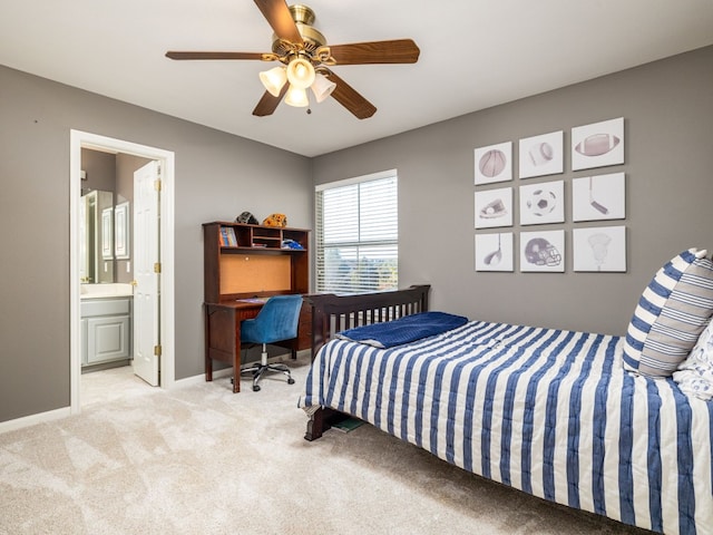 bedroom with ceiling fan, light colored carpet, and ensuite bathroom