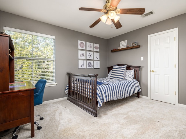 bedroom featuring light carpet and ceiling fan