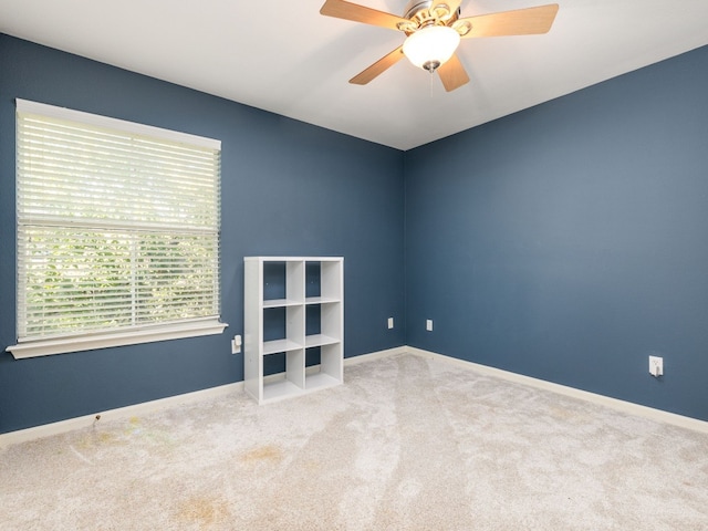 unfurnished room featuring ceiling fan and light carpet