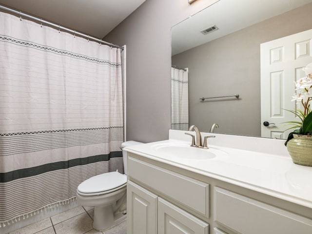 bathroom with tile patterned flooring, vanity, and toilet