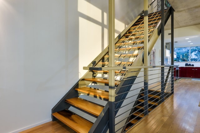 staircase featuring hardwood / wood-style flooring