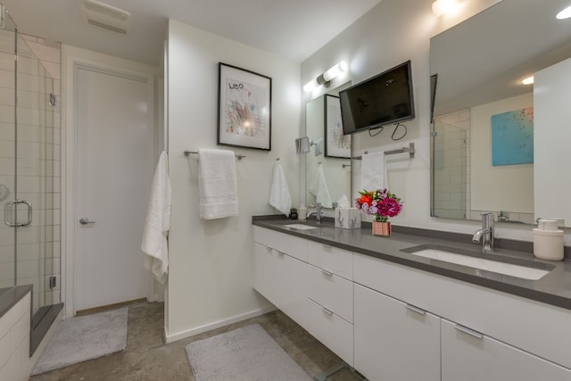 bathroom featuring walk in shower and vanity