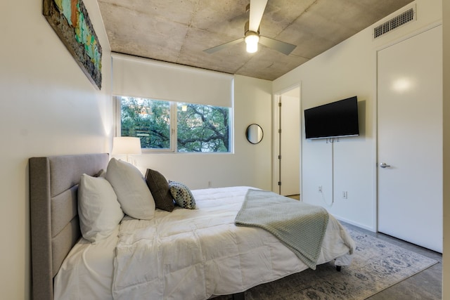 bedroom featuring concrete flooring and ceiling fan