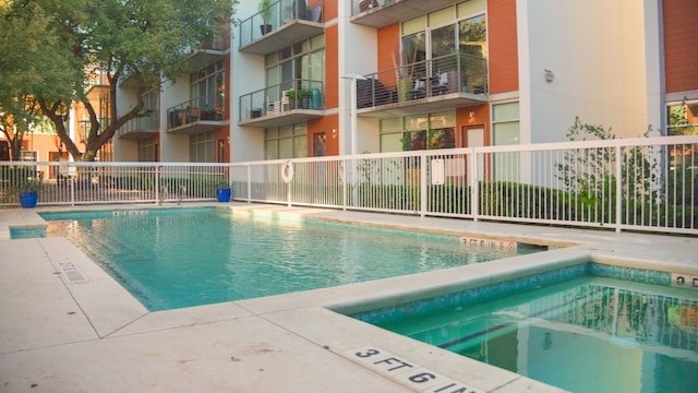 view of swimming pool featuring a community hot tub