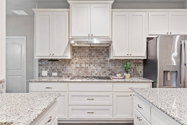 kitchen with white cabinetry, decorative backsplash, and stainless steel appliances