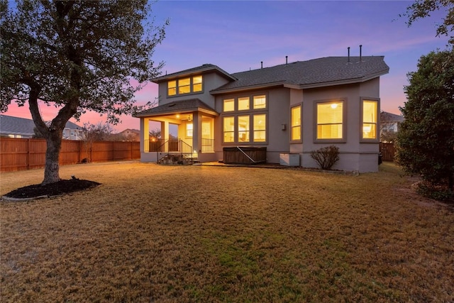 view of back house at dusk