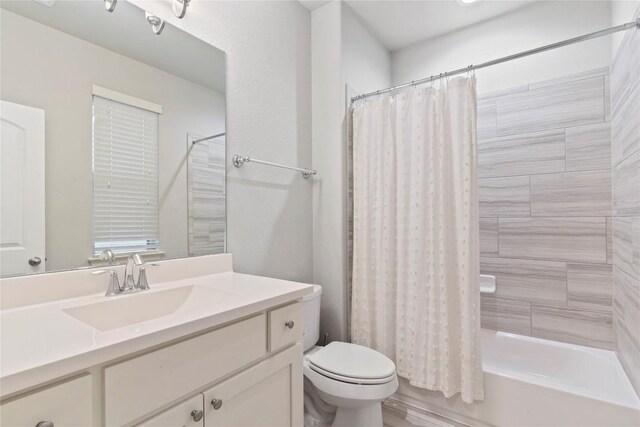 full bathroom featuring vanity, toilet, and shower / bath combo with shower curtain