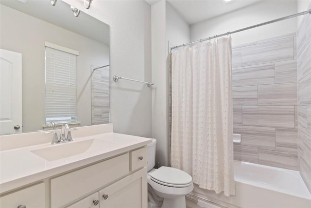 full bathroom featuring shower / tub combo with curtain, vanity, and toilet